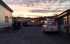 Sunset over office old cars